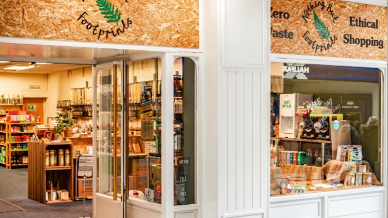A zero waste shop with glass doors and shelves stocked with eco-friendly products.